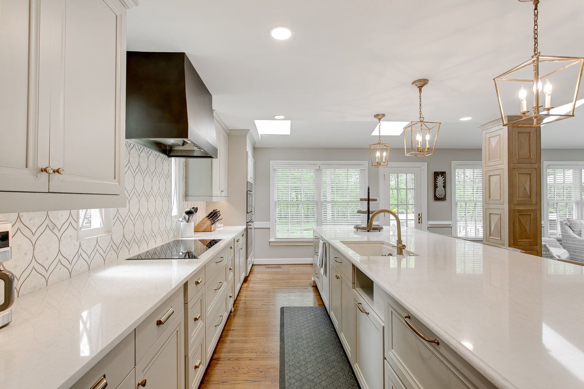 Bright and airy kitchen remodel with a large island and gold accents by Triple Crown Contractors in Apex, NC