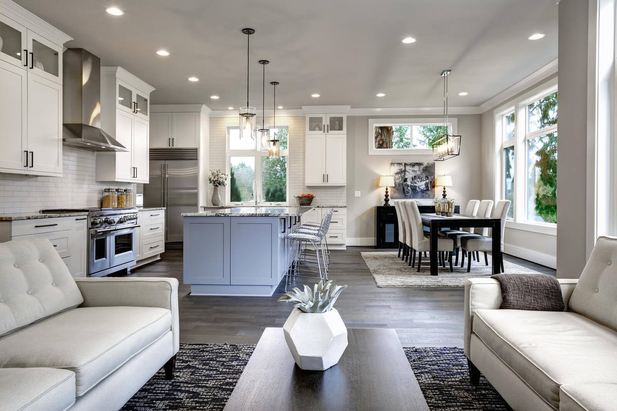 Elegant modern kitchen with white cabinetry, black accents, and pendant lighting in a renovated Durham, NC home