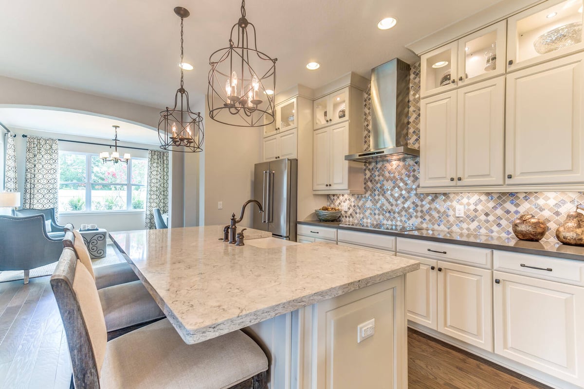 Luxurious kitchen renovation with marble countertops and pendant lighting by Triple Crown Contractors in Apex, NC