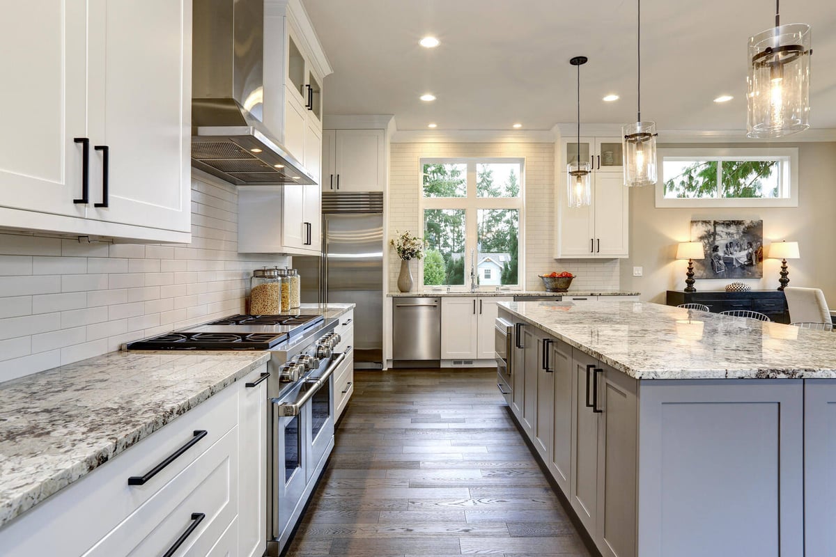 Modern kitchen with high-end finishes, stainless steel appliances, and a large central island in Durham, NC
