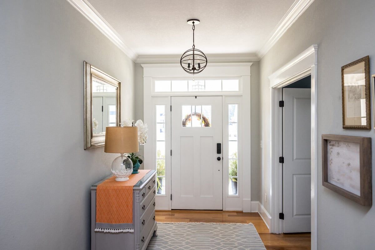 Stylish front entryway with a modern farmhouse door and elegant lighting, part of a whole home remodel in Apex, NC